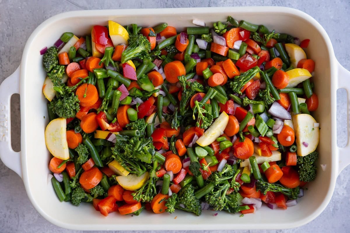 Chopped vegetables in a casserole dish ready to go into the oven.