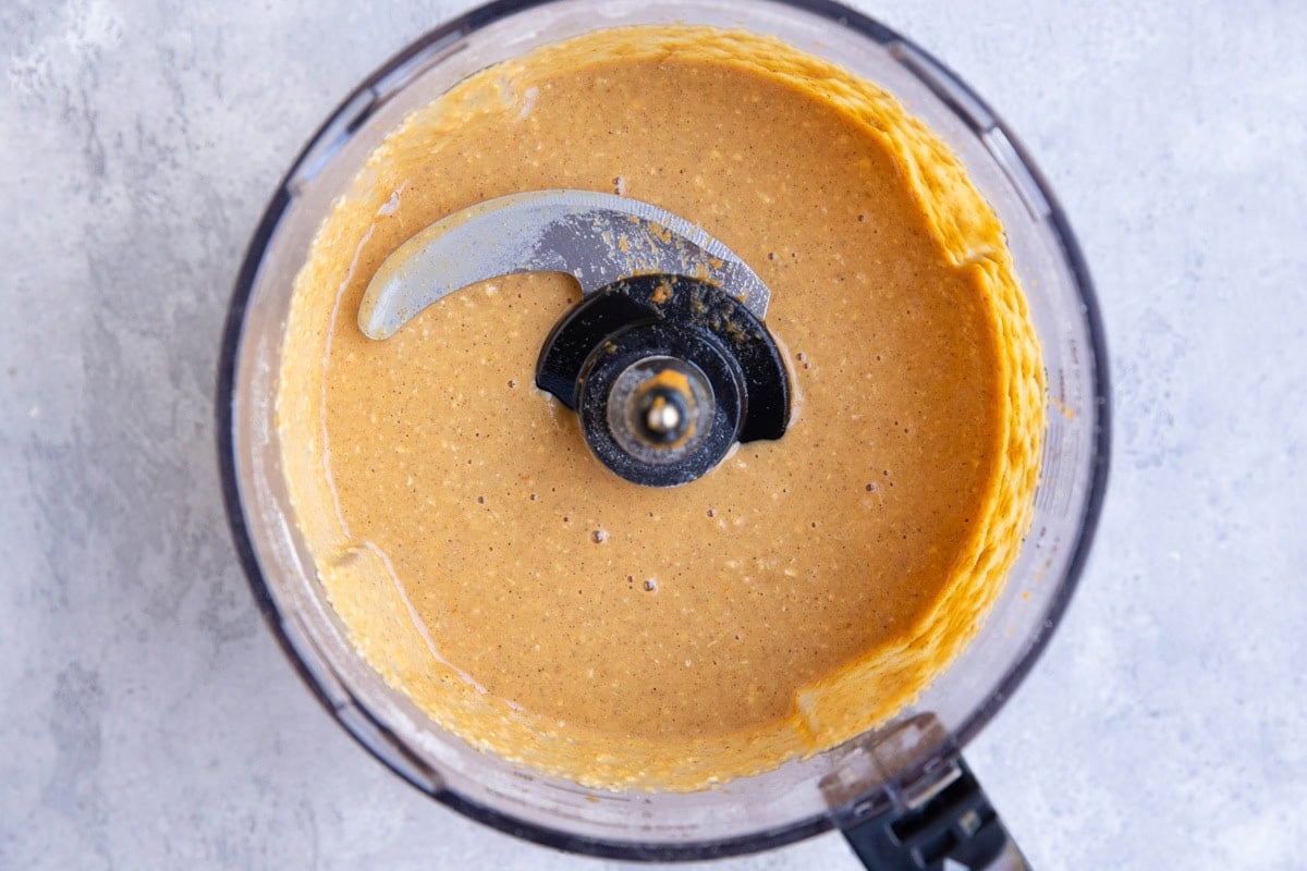 Food processor with pumpkin cake batter inside. Mixed together and ready to use.