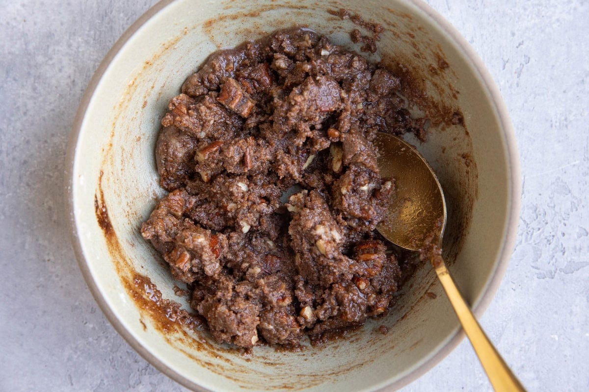 Bowl full of cinnamon pecan streusel topping mixture, ready to be used.