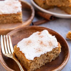 Wooden plates with spice cake slices and a plate of the rest of the cake slices in the background.