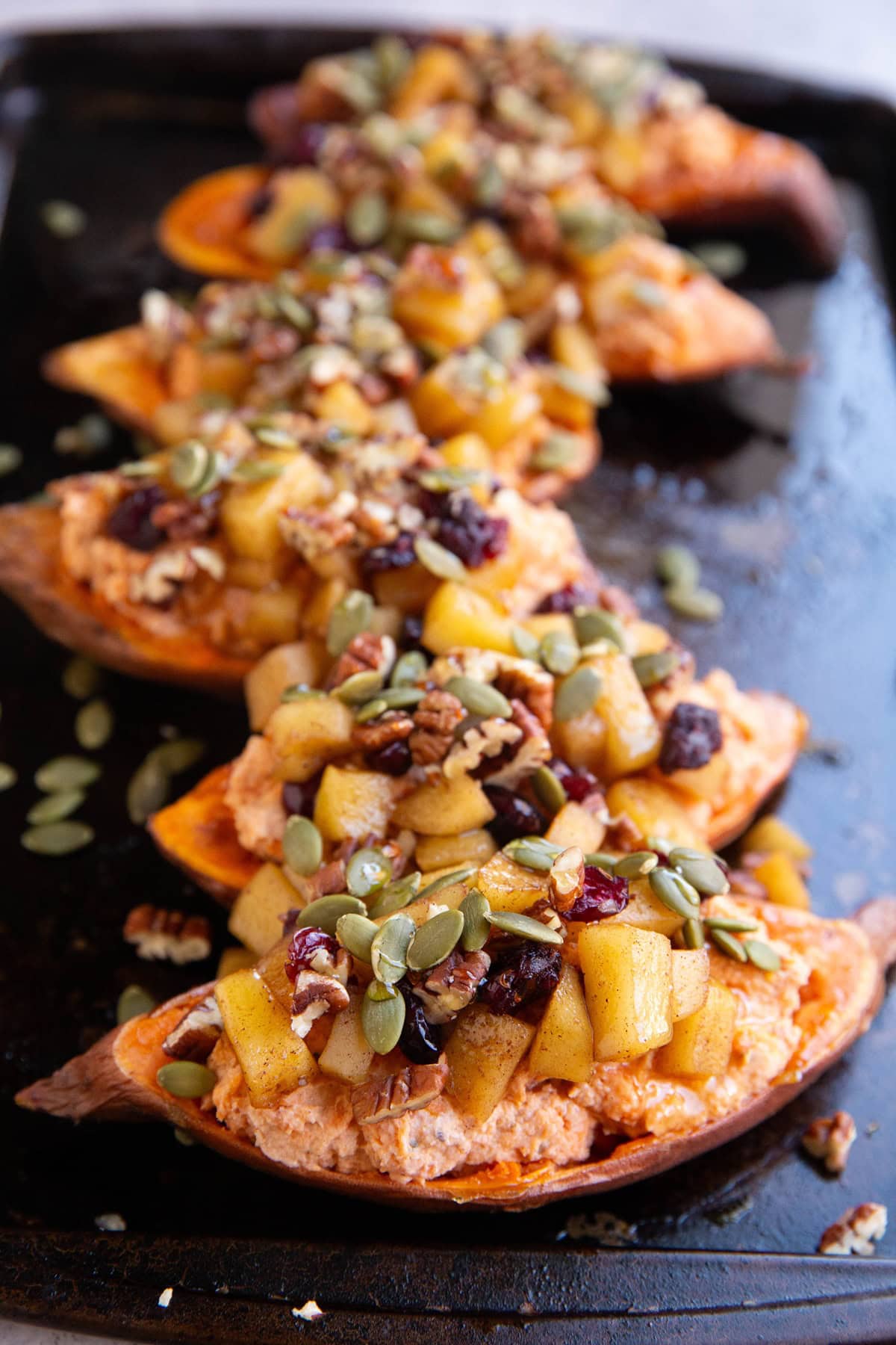 Six sweet potato halves stuffed with a yogurt mixture and topped with chopped cinnamon apples, pumpkin seeds, pecans and dried cranberries.